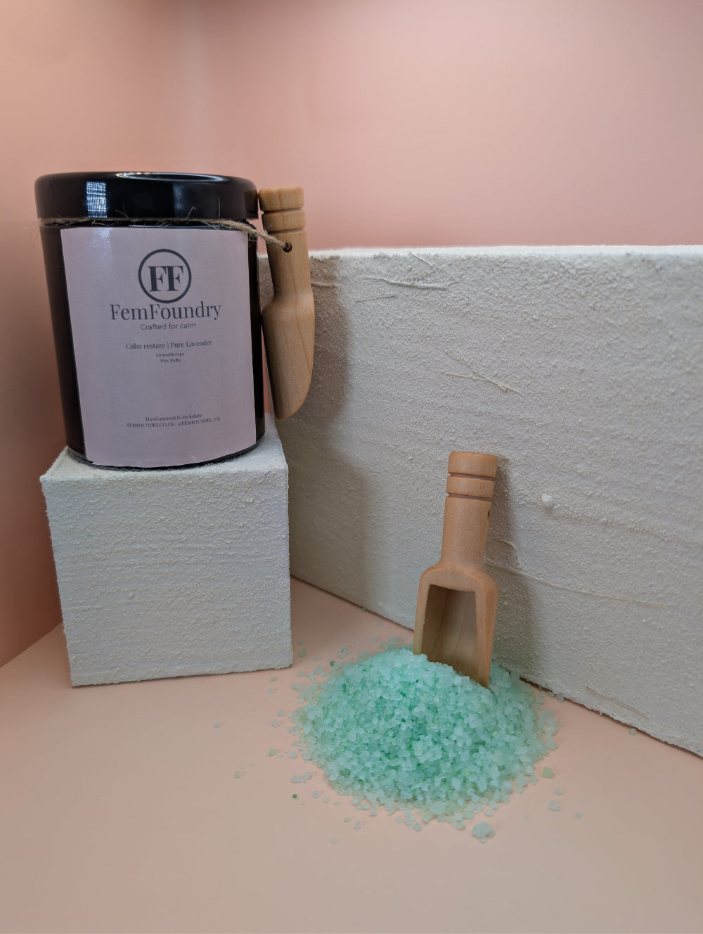 Calm Restore Bath Salts in an amber jar with pastel label, promoting a gentle, calming bathing experience.